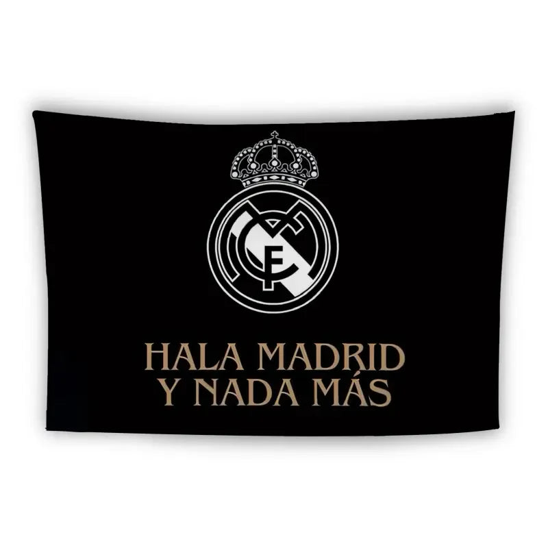 A black flag featuring the Real Madrid CF logo in white at the center. Below the logo is the text "HALA MADRID Y NADA MÁS" in uppercase gold letters, meaning "Go Madrid and nothing else." The logo includes a crown at the top.