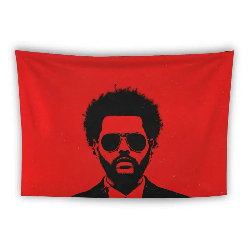 A graphic silhouette of a man with a distinct afro hairstyle, wearing sunglasses, a suit, and a turtleneck, set against a vibrant red background. The minimalist design emphasizes the contrasting dark figure and bright backdrop.