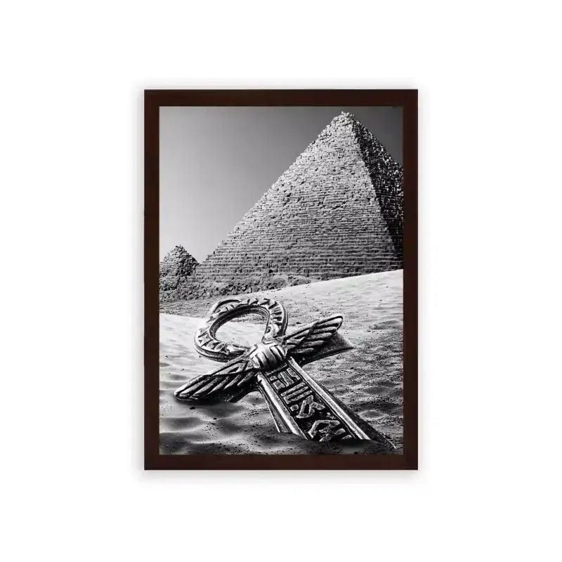 Ancient Egyptian 'Pyramid's Key' Framed Poster Brown Premium Wood A monochromatic photograph featuring the iconic great pyramid of giza with an ornate metallic key lying on the sand in the foreground, symbolically uniting ancient wonders with elements of mystery and discovery.