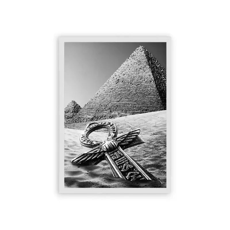 Ancient Egyptian 'Pyramid's Key' Framed Poster White Hard Fiber A monochromatic photograph featuring the iconic great pyramid of giza with an ornate metallic key lying on the sand in the foreground, symbolically uniting ancient wonders with elements of mystery and discovery.