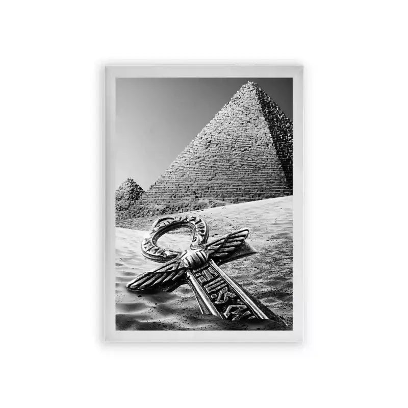 Ancient Egyptian 'Pyramid's Key' Framed Poster White Premium Wood A monochromatic photograph featuring the iconic great pyramid of giza with an ornate metallic key lying on the sand in the foreground, symbolically uniting ancient wonders with elements of mystery and discovery.