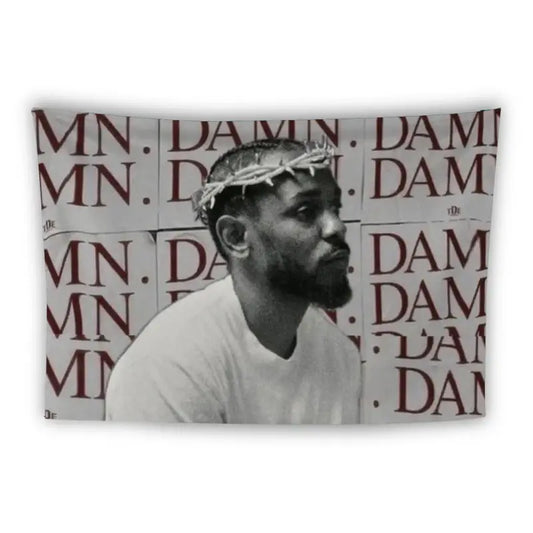 A man is wearing a white shirt and what appears to be a crown of thorns. He is looking to his left. The background consists of a repeated pattern of the word "DAMN" in red capital letters on white paper.