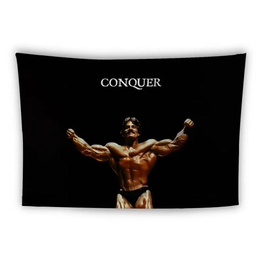 A muscular man in a bodybuilding pose flexes his arms and chest against a black background. The word "CONQUER" is written in white uppercase letters above him. He is wearing dark-colored briefs.