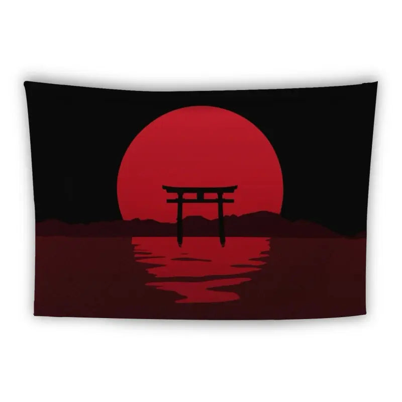 A Japanese torii gate is silhouetted against a large, red sun setting over a calm, dark body of water. The background features faint outlines of mountains, all set against a black sky.