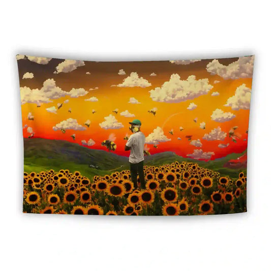 A person wearing a hat stands in a vast sunflower field at sunset. The sky is a gradient of warm tones with fluffy clouds, and bees are flying around. The landscape includes hills in the background.