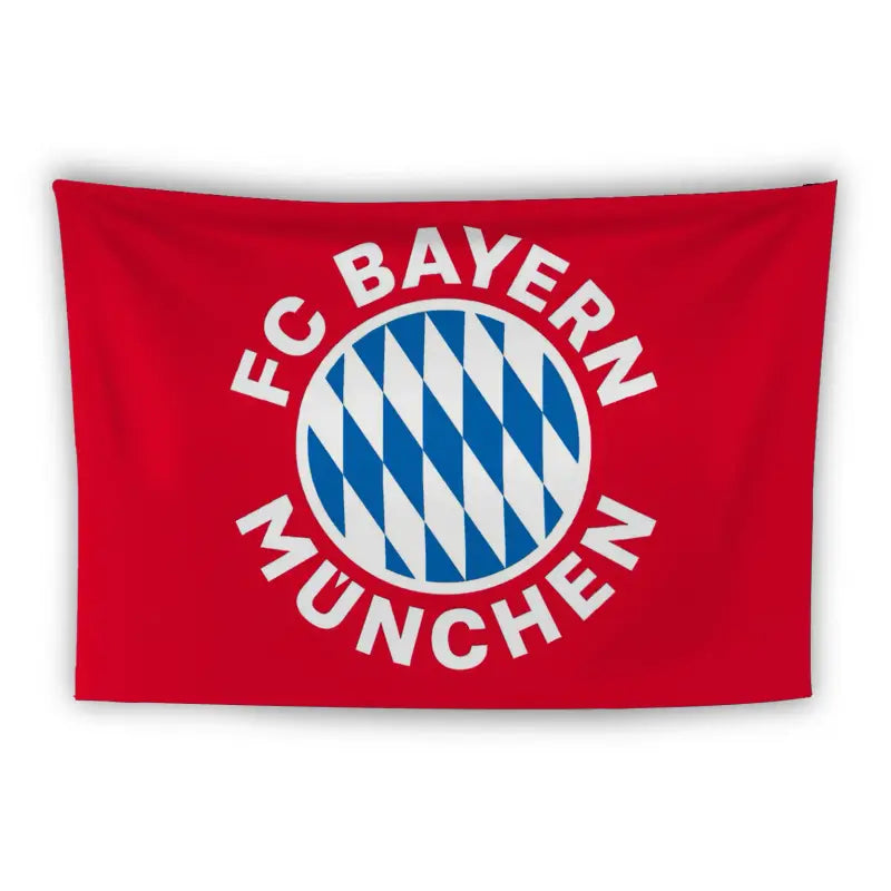 A red flag displays the FC Bayern München logo in the center. The logo features a blue and white diamond pattern circle, surrounded by the club's name in capital white letters: "FC Bayern München.