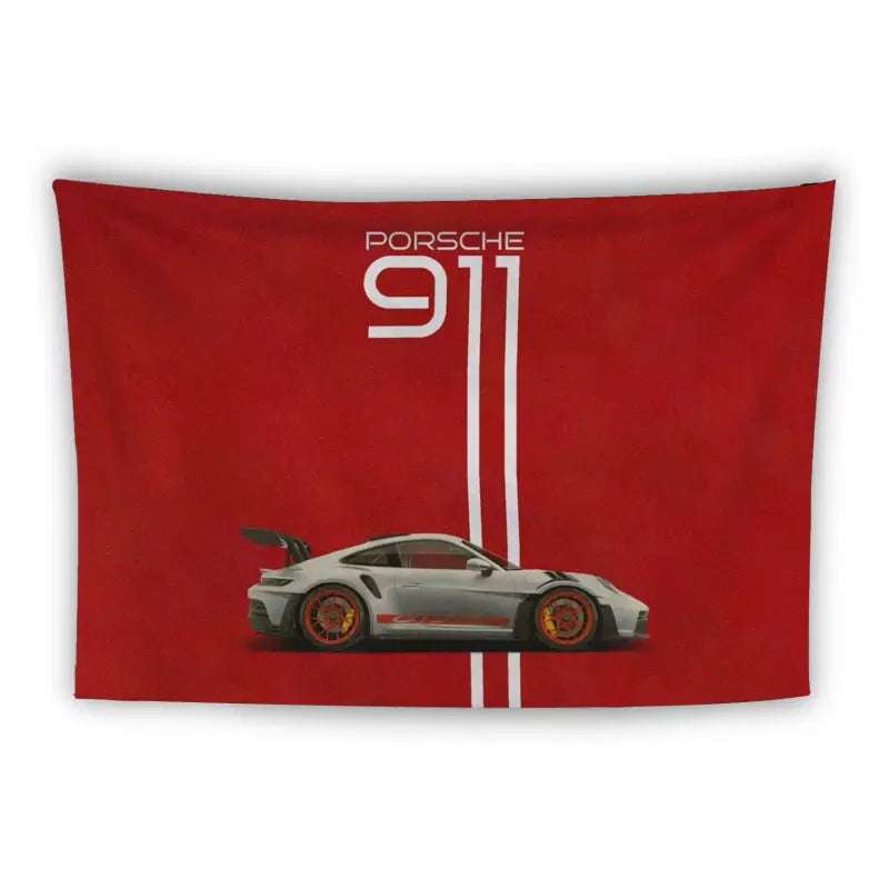 A red tapestry features an image of a white Porsche 911 sports car with red rims and a raised rear spoiler. Above, the text "Porsche 911" is written in white, with two vertical white stripes extending from the top to the car.