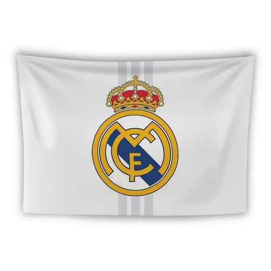 A white flag featuring the Real Madrid football club emblem in the center. The emblem consists of a gold and blue circular crest with the letters "MCF" intertwined and a red and gold crown on top. Two vertical grey stripes run behind the emblem.