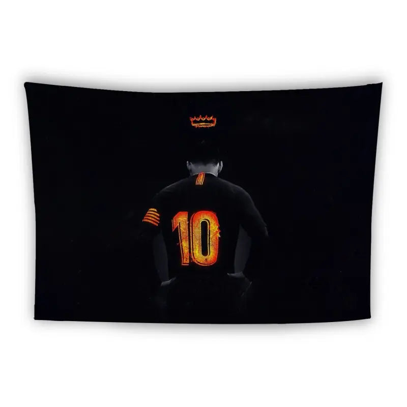 A person is shown from behind, wearing a black sports jersey with the number 10 in bold orange on the back. Above the person's head, a small orange crown hovers, all set against a black background.