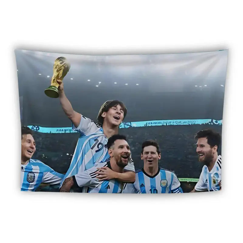 A jubilant soccer team celebrates on the field, with one player on another's shoulders holding the World Cup trophy aloft. Four other players surround them, smiling and wearing light blue and white striped jerseys, presumably of the Argentina national team.