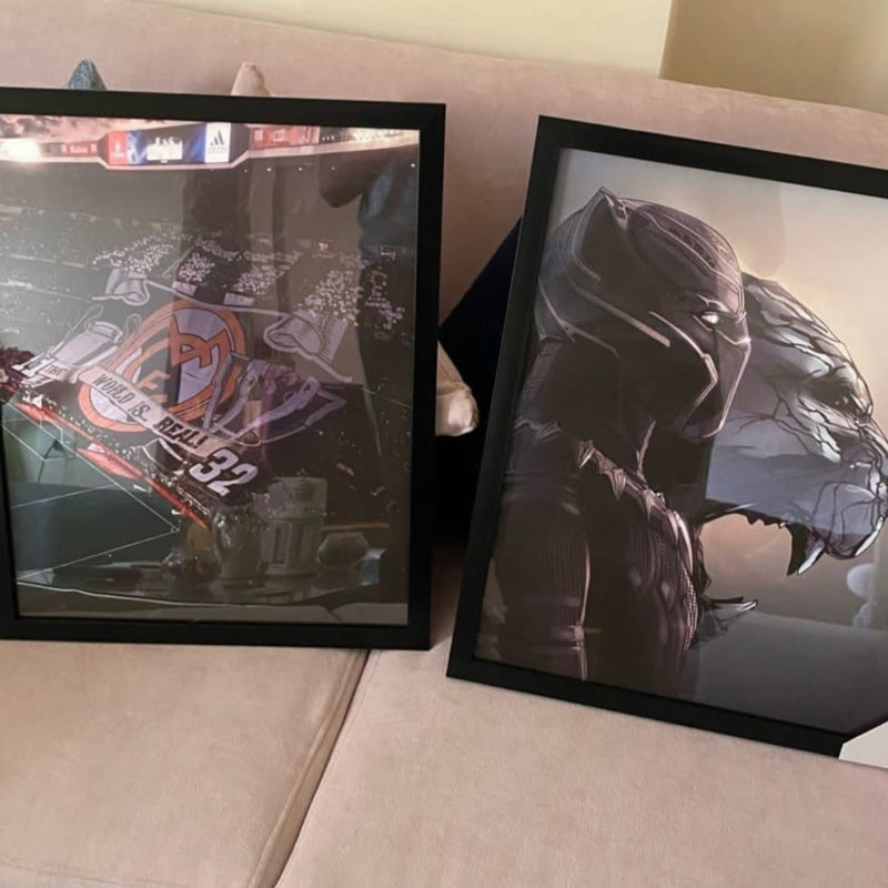 Two framed posters on a sofa