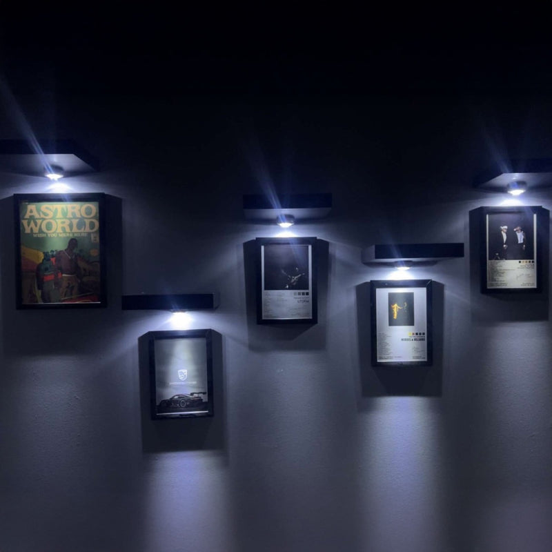 Five spotlit Spark frames on a dark wall
