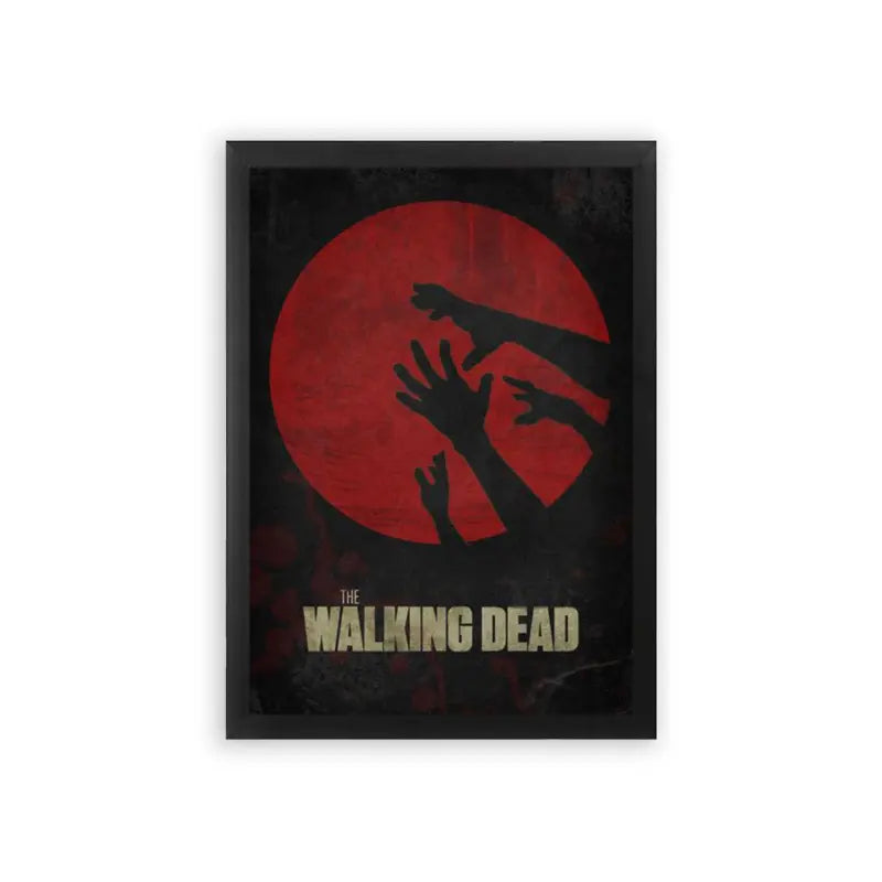 The Walking Dead 'Grips of the Undead' Framed Poster Black Premium Wood The image is a poster for the tv series "the walking dead." it features a dark silhouette of a group of hands reaching upwards against a backdrop of a red circle, suggesting a sense of horror and desperation, which is fitting for the show's zombie apocalypse theme.