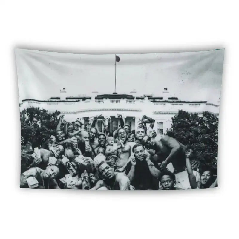 A black-and-white image shows a large group of people gathered in front of a building that resembles the White House. The group is predominantly young, and many are posing energetically, some with arms raised, exuding a joyful and celebratory atmosphere.