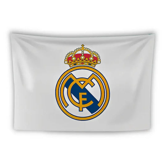 A white flag featuring the emblem of the football club Real Madrid. The emblem consists of interlocking letters "M", "C", and "F" in blue, topped with a golden crown adorned with red and white details.