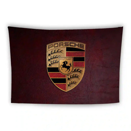 A red and black Porsche logo featuring a golden shield divided into quarters with a prancing horse in the center. The top section has "Porsche" in gold and a black stripe pattern, with antlers in the other quarters. Set on a dark maroon background.