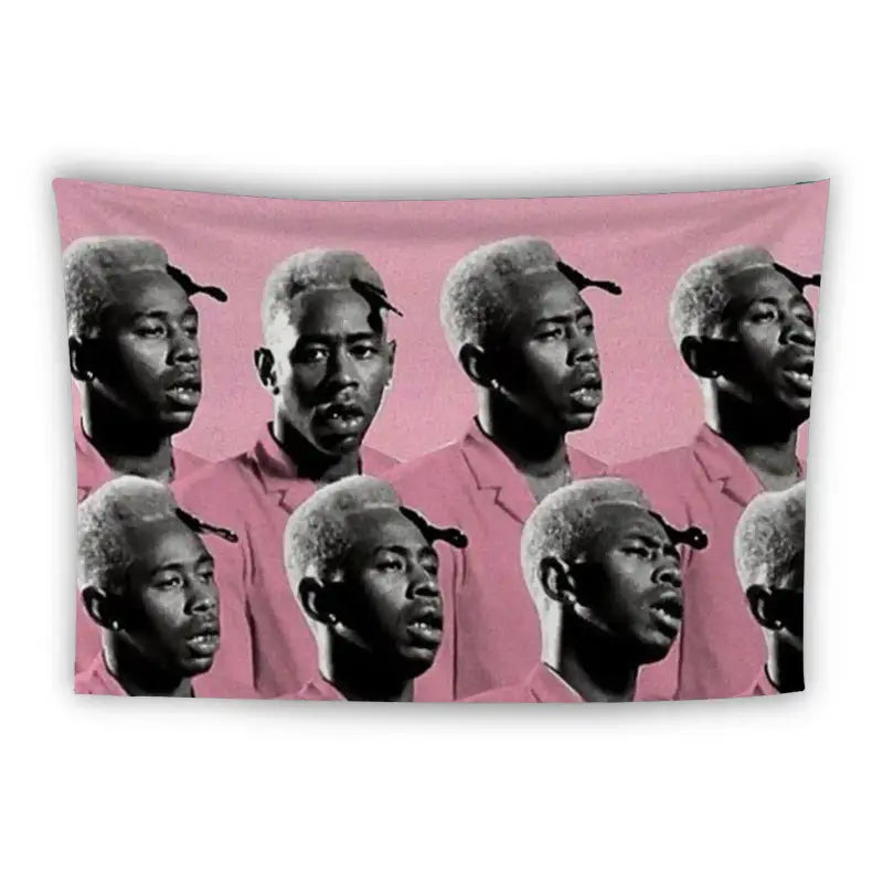 A tapestry features multiple instances of a man with blonde hair wearing a pink shirt, all set against a pink background. The repeated image shows various expressions, including some with serious looks and others with mouths slightly open.