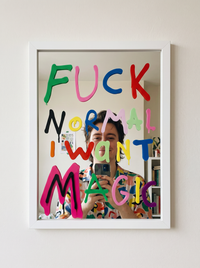 White wood-framed wall mirror printed with colourful drippy F*ck Normal I Want Magic lettering