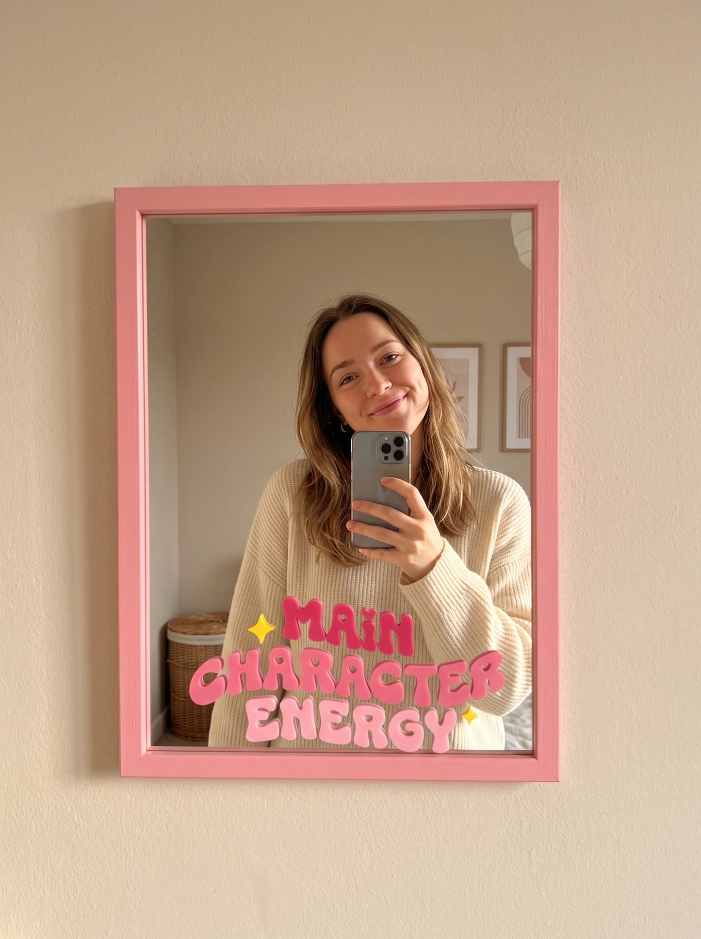 Pink wood-framed wall mirror with Main Character Energy in pink bubble lettering and sparkle icons