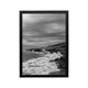 Framed black and white coastal waves and rocky shoreline print for modern minimalist living room or hallway