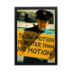 A captivating wall art featuring a man holding a sign 'SLOW MOTION IS BETTER THAN NO MOTION,' lit with vibrant tones for modern offices.
