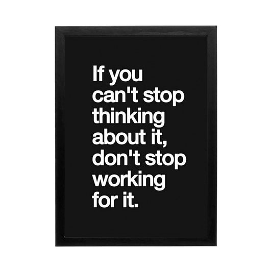 Bold motivational wall art with white text on black background, ideal for a high-performance workspace.