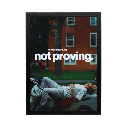 Stylish wall art featuring a man relaxing on a motorbike, depicting the 'focus on improving' mindset, ideal for a motivational workspace.